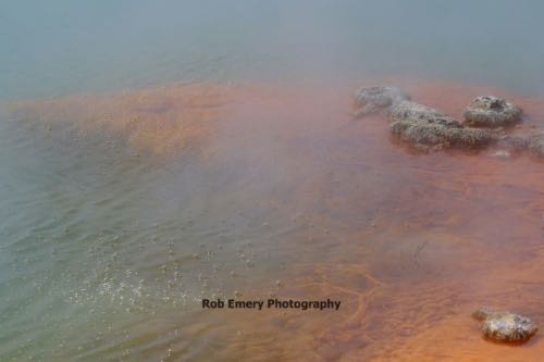 bubbly lake with orange sediment